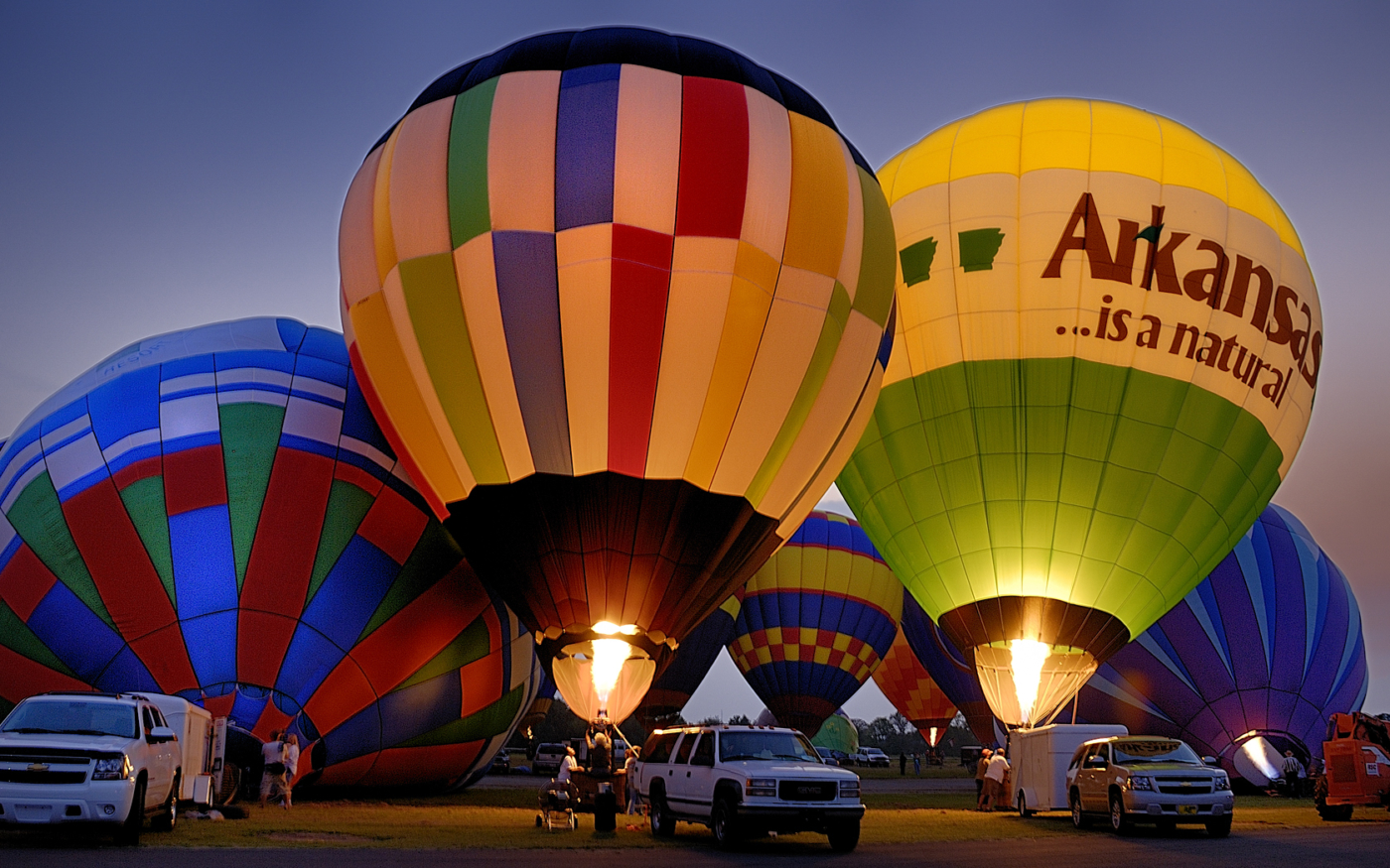 Hot air balloons being inflated at sunset in Hot Springs, Arkansas.